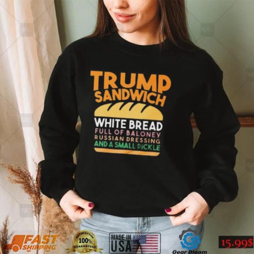 Trunp sandwich white bread full of bakone y russian dressing and a small picke shirt