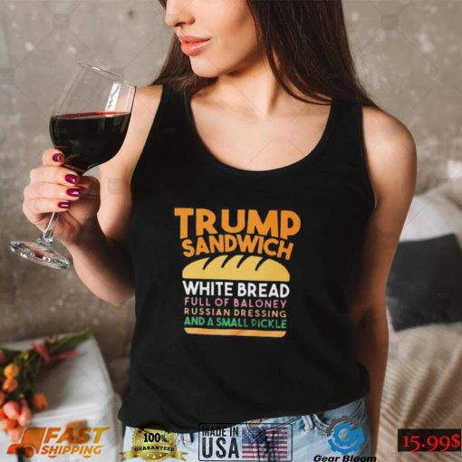 Trunp sandwich white bread full of bakone y russian dressing and a small picke shirt