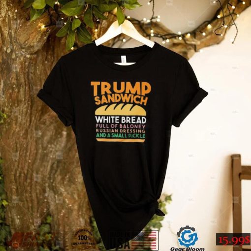 Trunp sandwich white bread full of bakone y russian dressing and a small picke shirt