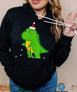 Dinosaur putting up string lights Christmas shirt