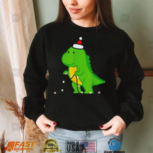 Dinosaur putting up string lights Christmas shirt