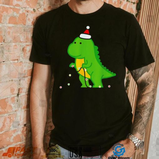 Dinosaur putting up string lights Christmas shirt