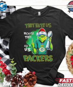The **Grinch Packers Super Bowl Christmas They Hate Us Because They Ain't Us Shirt** combines holiday cheer with a bold statement of sports pride, blending the infamous Grinch character with the iconic Green Bay Packers. The phrase 