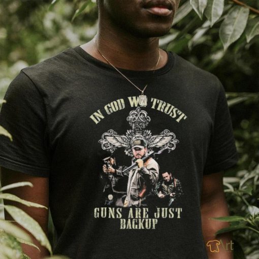 Cross and the man holding gun in god we trust guns are just backup shirt