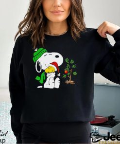 Snoopy hugs his Christmas day Woodstock shirt