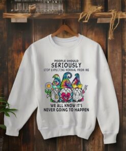 **Gnomes People Should Seriously Stop Expecting Normal From Me Shirt** featuring a whimsical design with quirky gnome illustrations and the humorous phrase in bold, playful typography. Perfect for those who embrace their unique personality and want to showcase it with charm and a touch of humor.