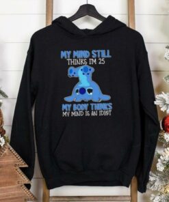 **Stitch My Mind Still Thinks I’m 25, My Body Thinks My Mind Is An Idiot Shirt** – a humorous shirt for those who feel young at heart but their body has other ideas. Featuring Stitch for a fun, nostalgic touch!
